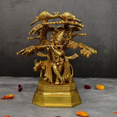 brass krishna idol under the kadamb tree