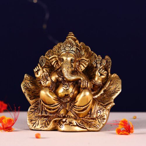 brass lord ganesh idol seated on flower couch