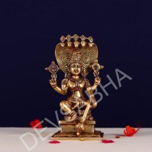 brass lord narayan statue sitting on shesh nag