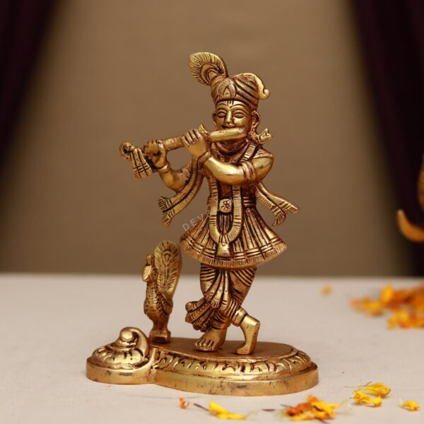 Brass lord krishna idol playing flute with peacock