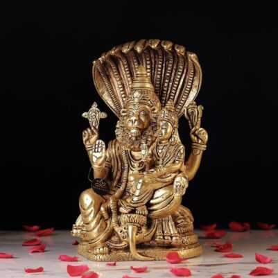 Intricate detailing on the lion's face highlights the Brass Laxmi Narasimha Idol, surrounded by rose petals.
