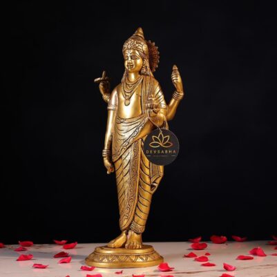 The statue depicts Dhanvantri gracefully holding a pot and a conch, surrounded by rose petals.