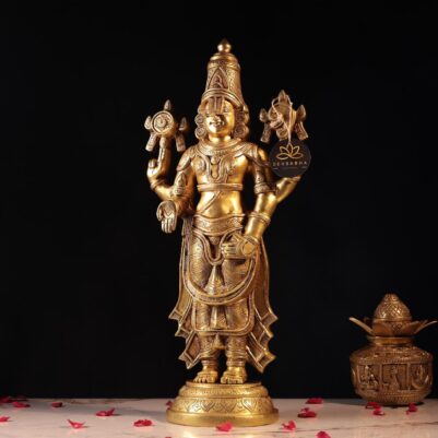 Intricate floral patterns carved on the attire of the golden Venkateshwar statue standing upright