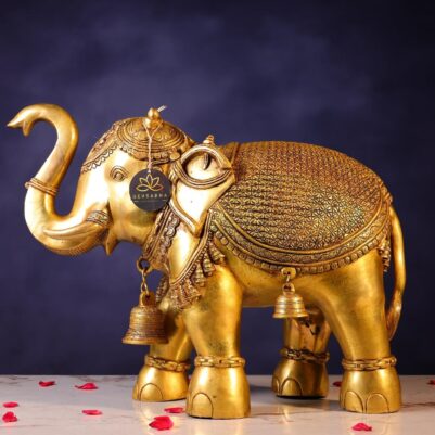Intricate floral patterns cover the back, with hanging bells on legs, brass elephant statue side view