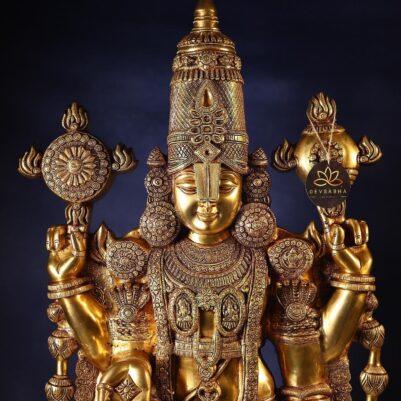 Detailed floral motifs on the crown and arm adorn this polished brass Tirupati Balaji idol.