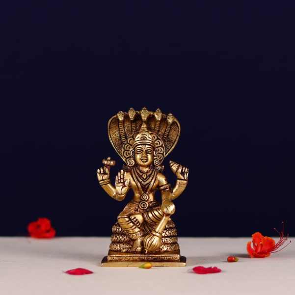 brass lord vishnu murti sitting on shesh nag